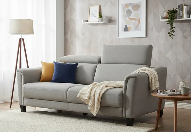 Harper sofa in soft grey fabric with a cream throw